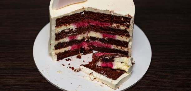 istock Cut cake with cherry flavor and vanilla frosting 1438116434