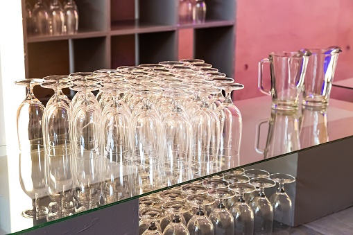 A closeup shot of upside down glasses on a bar counter