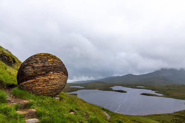 Beautiful scenery of a loch in Knockan Crag National Nature Reserve in Northwest Highlands, Scotland A beautiful scenery of a loch in Knockan Crag National Nature Reserve in the Northwest Highlands, Scotland crag stock pictures, royalty-free photos & images