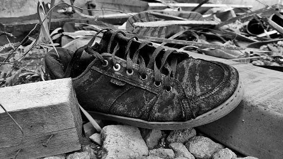 High angle view of lots of female shoes abandoned in the street in the city of Valencia, Spain