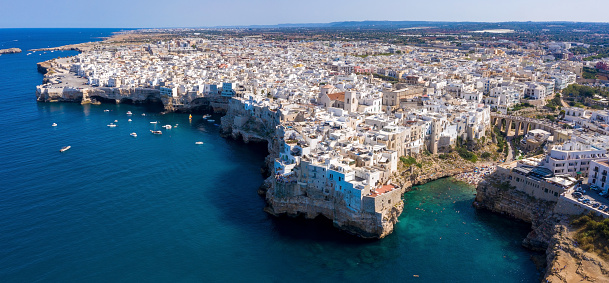 An aerial shot of the Adriatic sea  and cityscape of Polignano a Mare town, Apulia, southern Italy