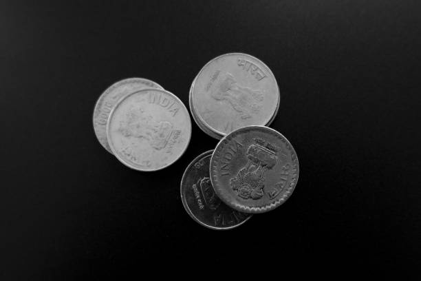 istock Top view of old Indian coins on a black surface under the lights 1438117798