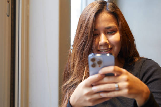 istock happy and beautiful lady communicating with mobile device 1438117961