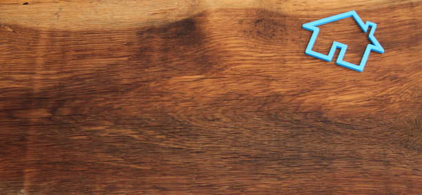 istock an old oak board with a house as a background 1438118426