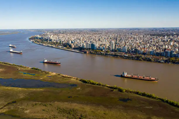 image without recognizable marks or people

Aerial shot over parang River in Front of Rosario City 
four ships waiting to be loaded with grain