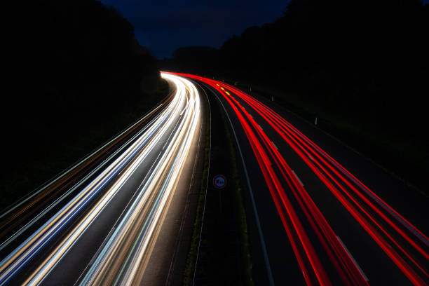 istock Light trails on illuminated city against the sky at night 1438118776