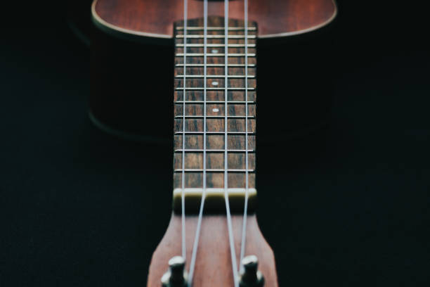 istock Closeup shot of a wooden ukulele with strings 1438118884