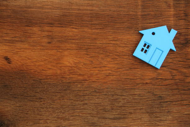 istock an old oak board with a house as a background 1438119103