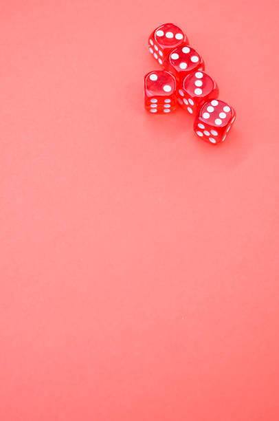 istock Vertical high angle shot of playing dice on an isolated pink background 1438119174
