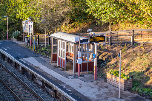 A station England UK. Diesel powered railway line in the English countryside. Station on a sunny day.