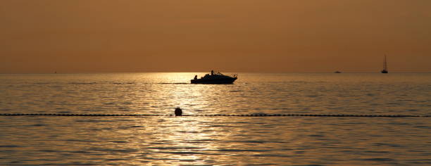 Sunset with a yacht on Lake Garda in the background