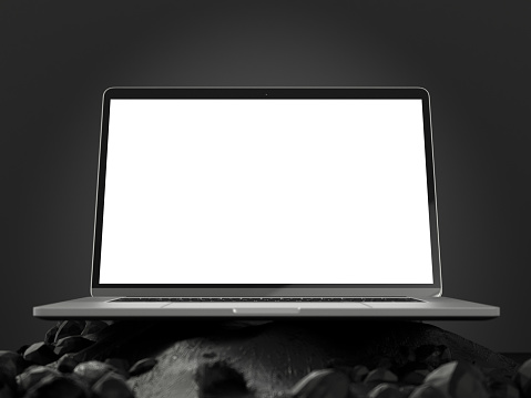 Laptop with Blank White Screen on Abstract Black Rock Surface. 3D Render