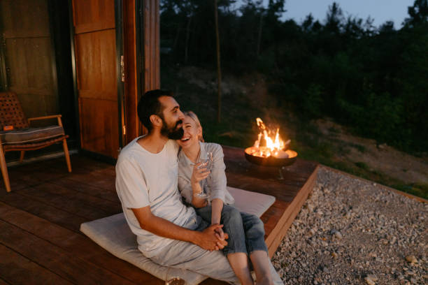 istock Young couple drinking wine by the fire pit 1438123558