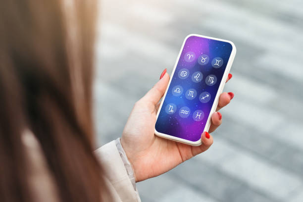 istock zodiac signs astro forecast. a woman holds a mobile phone with an astrological application 1438123760