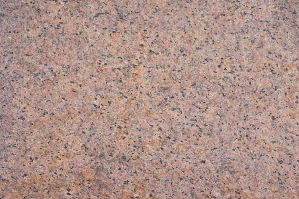 istock Background from red granite with potholes. Top view 1438123822