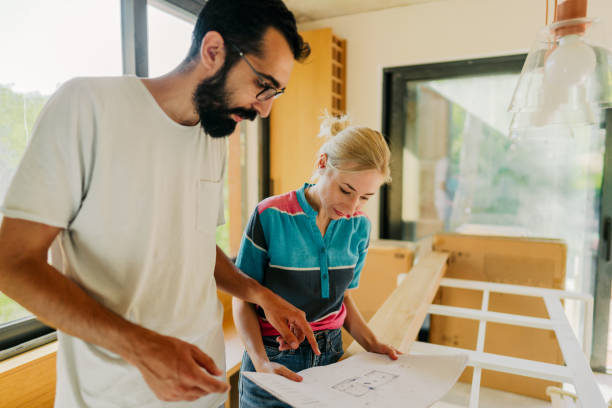 istock Checking architectural project of our new home 1438124271