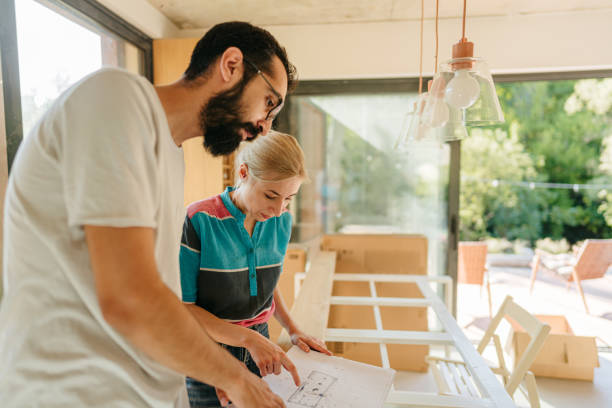 istock Checking architectural project of our new home 1438124305
