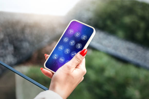 istock astro forecast. a woman holds a mobile phone with an astrological application 1438125501