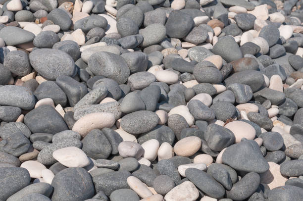 istock Grey and White stones / Beach stone on grey and white 1438125538