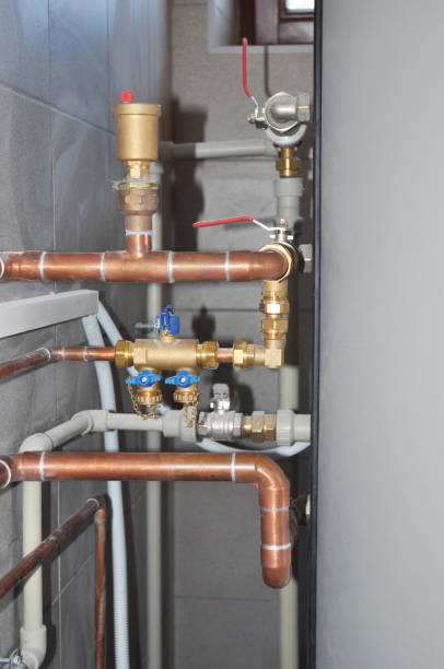istock Copper pipes heating system. House heating system copper pipes.  Copper pipes of solar water heater system in boiler room. 1438126107