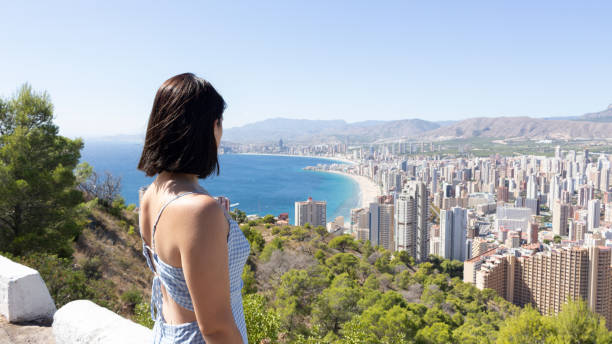 istock Young female looking at Benidorm cityscape 1438128374