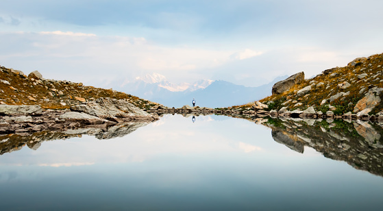 Back view person female stand on edge in nature calm landscape look to sides search purpose in life alone in scenic mountains in fall