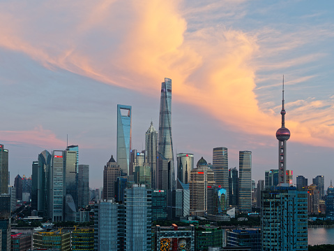 modern skyscrapers, Shanghai tower, jin mao tower, oriental pearl TV tower and shanghai world financial center, landmarks in lujiazui with beautiful sunset background.