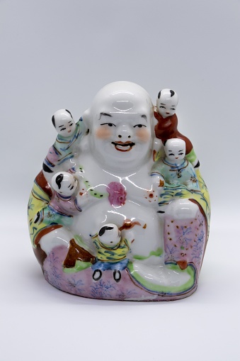 A Figurachina of a happy cartoon with happy cartoon children all over it on a white background