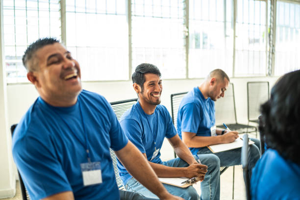 istock Volunteers paying attention and smiling on a community center presentation 1438130611