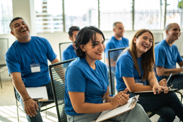 Volunteers paying attention and smiling on a community center presentation