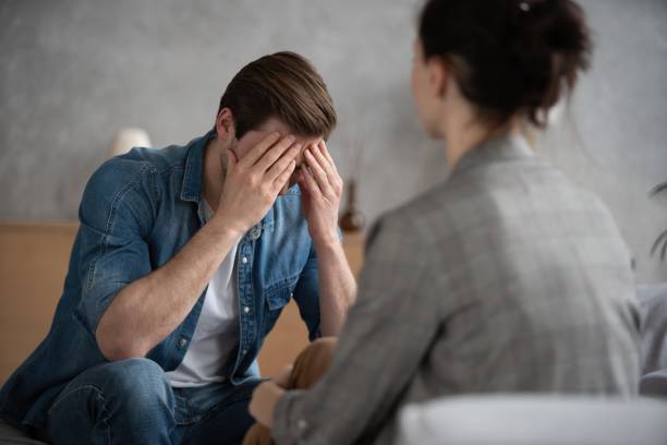 istock Psychologist talking with patient on therapy session. 1438131155