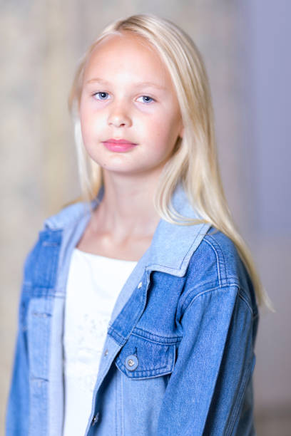 istock Blonde girl wearing a blue denim jacket 1438131192