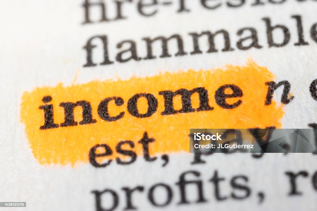 Income Word written and underlined in a dictionary Banking Stock Photo