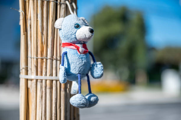 istock Light blue toy bear on the roadside in the sunshine 1438131784