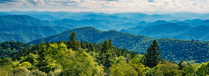 Beautiful summer mountain panorama. Green mountains and layers of  hills. View of Smoky Mountains from Blue Ridge Parkway. Near Asheville, North Carolina. USA.