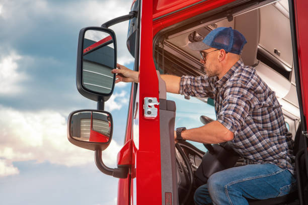 istock Truck Driver Adjusting Side Mirrors On Semi Truck 1438135505