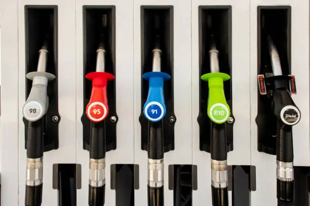 Petrol pumps hoses on a petrol station in Australia - 98, 95, E10, 91, diesel. Fuel nozzles oil dispensers. Petrol diesel fuel prices concept