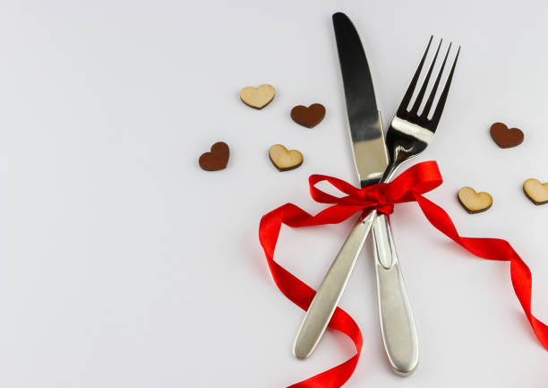 istock Silver fork and knife decorated red ribbon 1438135633