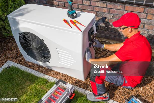 Technician Repairing Heat Pump Unit Stock Photo - Download Image Now - Heat Pump, Air Conditioner, Repairing