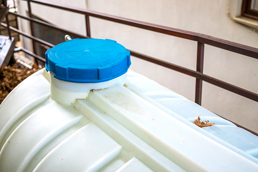 Blue water tank on rooftop