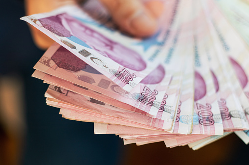 Close-Up Man Hand And Giving Turkish Lira. Finance And Economy.