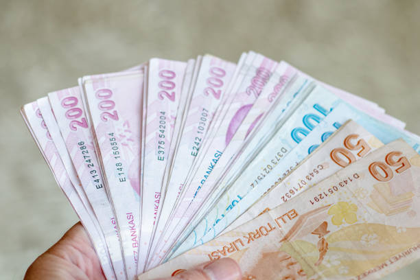 istock Close-Up Man Hand And Giving Turkish Lira 1438137526