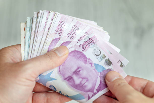 istock Close-Up Man Hand And Counting Turkish Lira 1438137636