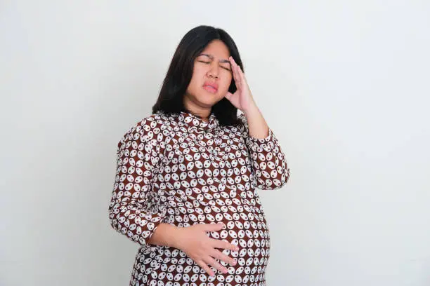 Pregnant asian women suffering headache