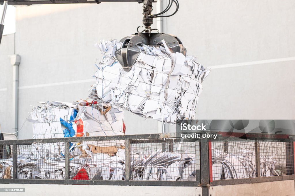 Big crane dropped scrap on pile. Industrial grabber. Bales for recycling Recycling Stock Photo