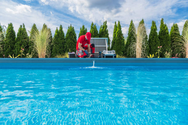 Professional Swimming Pools Technician Performing Seasonal Maintenance stock photo