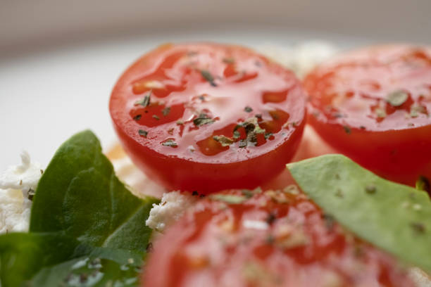 toasts with feta cheese and cherry tomatoes on a white dish, macro shot, healthy snack
