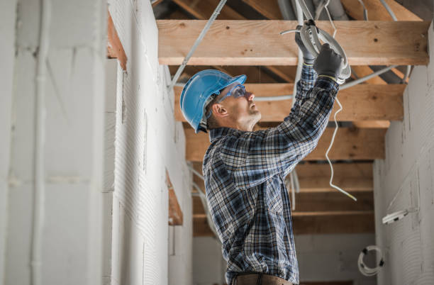 Professional Electrician Installing Ceiling Light Point stock photo