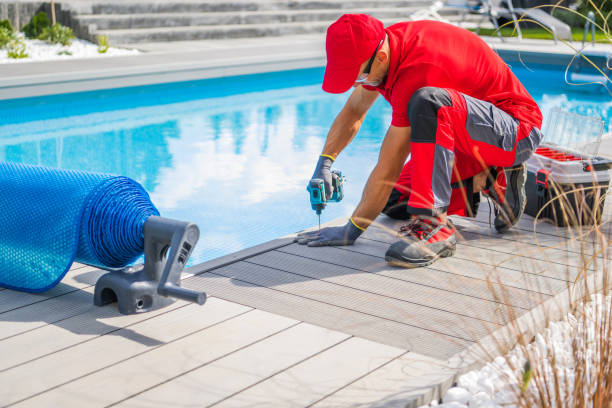 istock Professional Outdoor Swimming Pools Worker Finishing Composite Deck Installation 1438145249