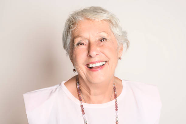 istock smiling retired senior woman looking at camera isolated on white background 1438145643